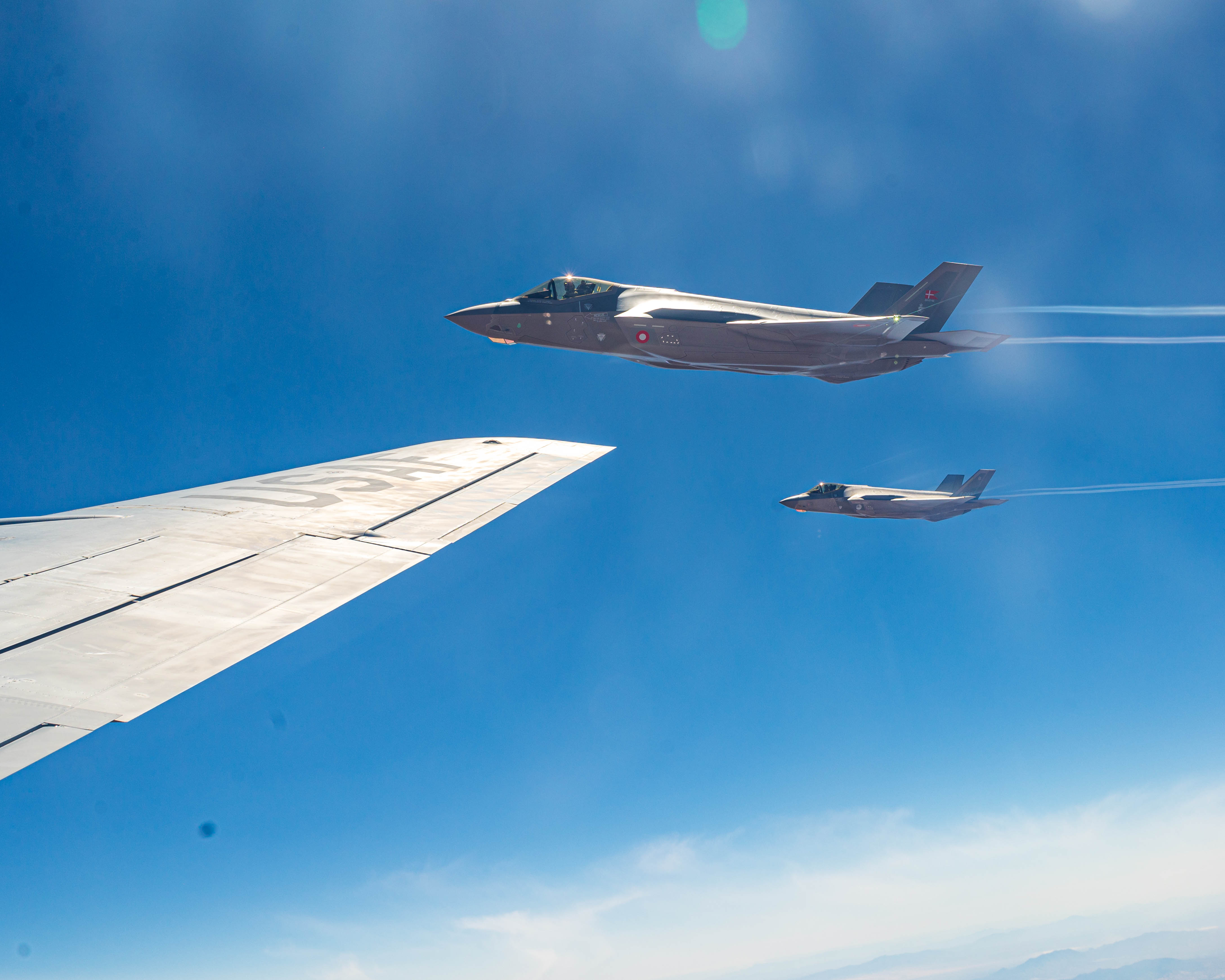 A U.S Air Force KC-135 Stratotanker, assigned to the 161st Air Refueling Wing flies alongside an F-35A Lightning II assigned to the 56th Fighter Wing, April 24, 2025