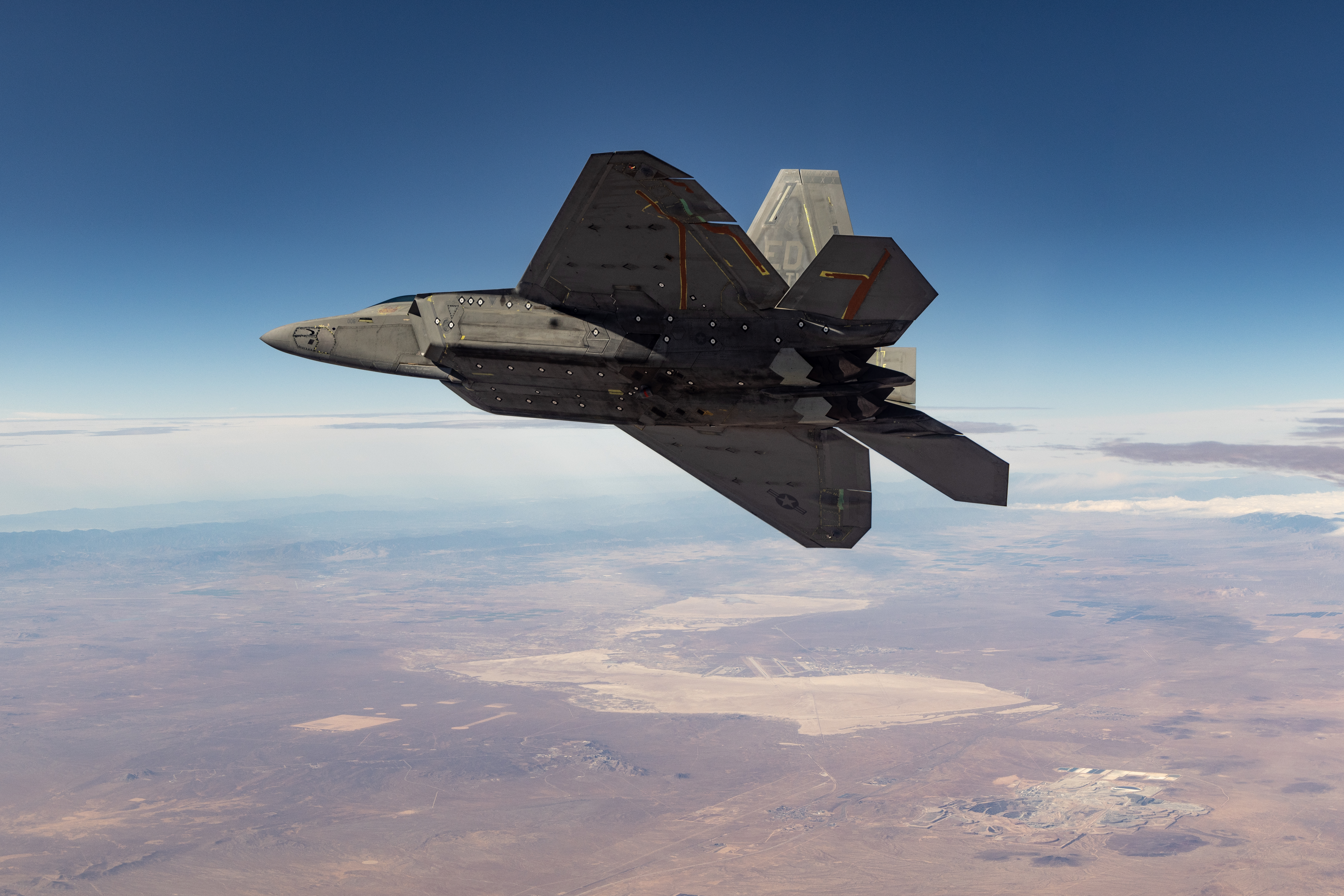An F-22 assigned to the 411th Flight Test Squadron, Air Dominance Combined Test Force, banks near Edwards Air Force Base, CA during an early morning test mission