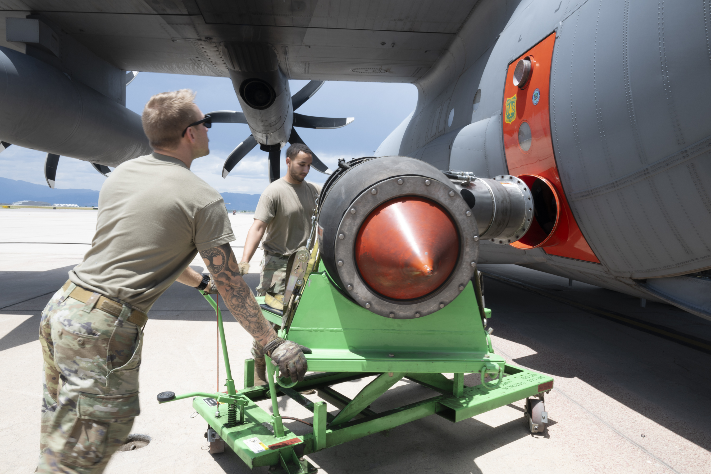 A 302d Aircraft Maintenance Squadron team installs a Modular Airborne Fire Fighting System nozzle onto a C-130H Hercules aircraft at Peterson Space Force Base, Colorado, July 21, 2025