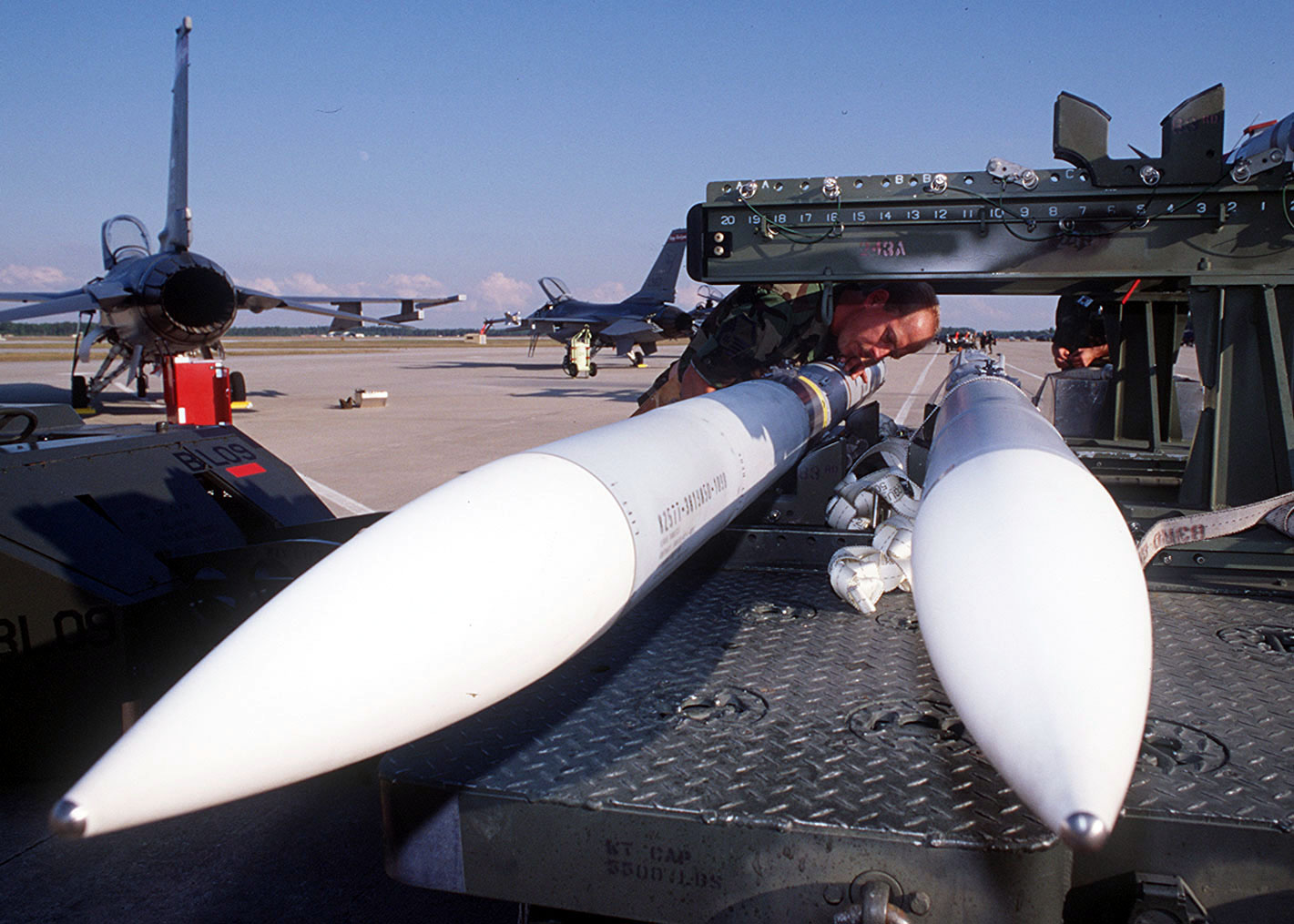 Master Sgt. Kevin Nelson inspects an AIM 120 Advanced Medium-Range Air-to-Air Missile before loading it onto a F-16 Fighting Falcon at Tyndall Air Force Base, Fla., on Oct. 22, 1996