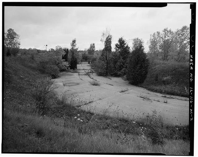 Acid Fueling Station - CONCRETE PADDING AREA BETWEEN BERM MOUNDS, LOOKING NORTH FROM TOP OF BERM