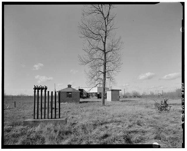 View WEST, fuel pump houses, theater, two steel sheds, water pump house